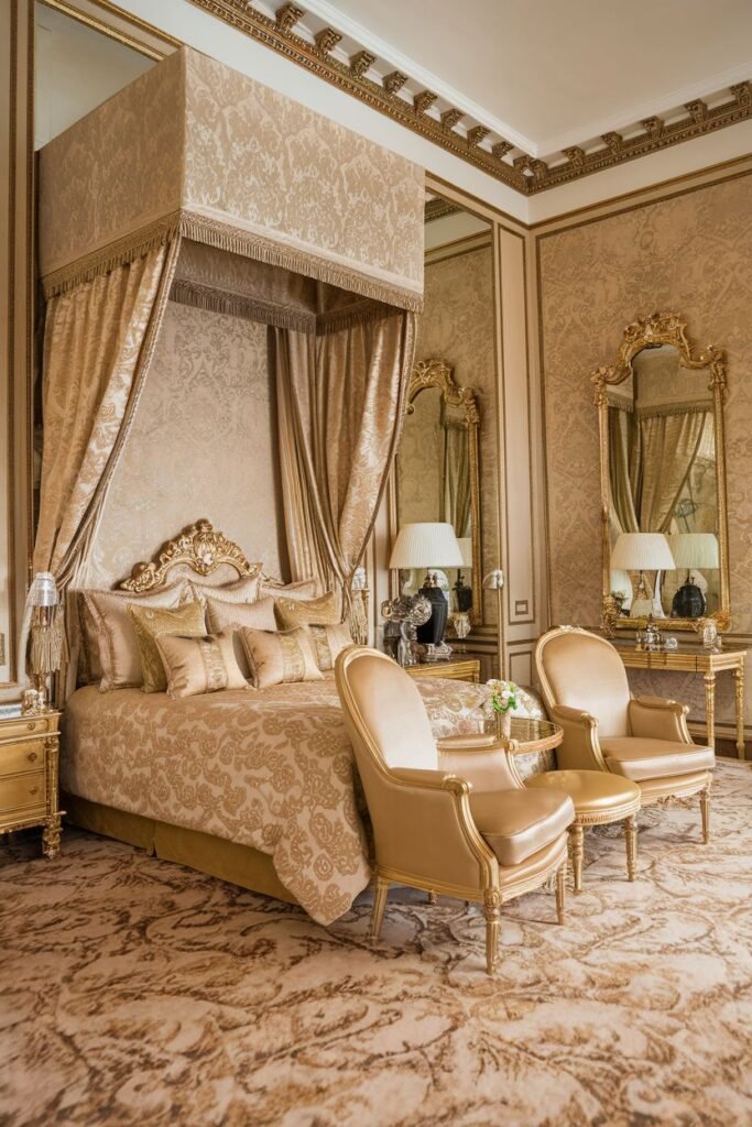 A golden royal bedroom highlighting ornate details, a canopy bed with decorative fabric, gilded chairs, elaborate wall coverings, and coordinated bedding, creating a comfortable royal atmosphere.