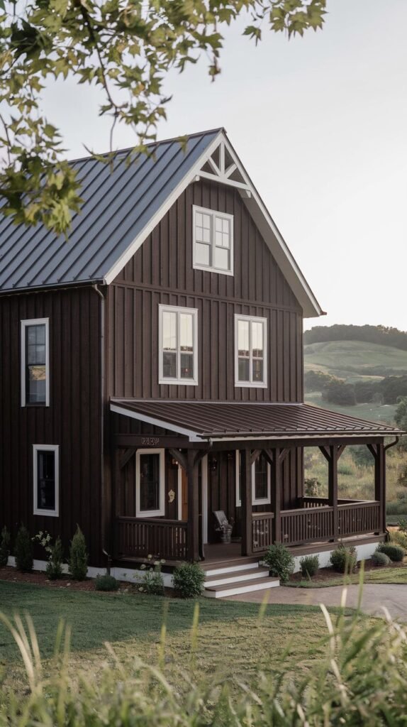 Two-story dark brown farmhouse with vertical siding and a covered front porch.