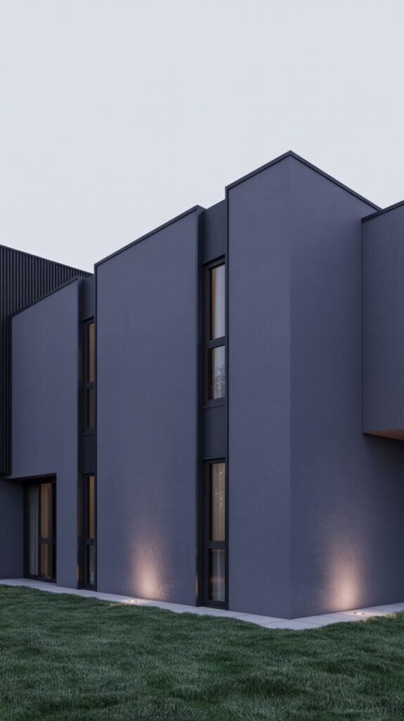 Modern house with sections of different dark grey tones, vertical siding, and spotlights.