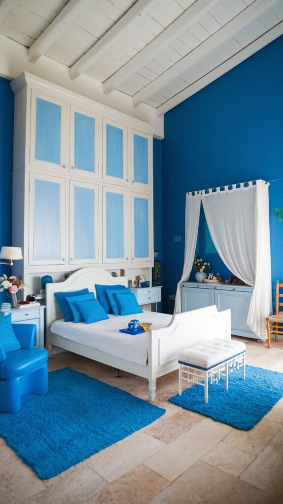 A beautiful and dreamy blue and white bedroom with rustic elements, featuring a white bed with blue pillows, a tall white and blue cabinet, and two vibrant blue shaggy rugs on a stone floor.
