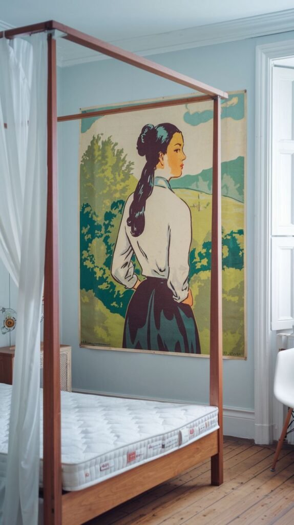 Minimalist bedroom with a wooden canopy bed and a large retro-style poster of a woman overlooking a green countryside landscape on the wall.