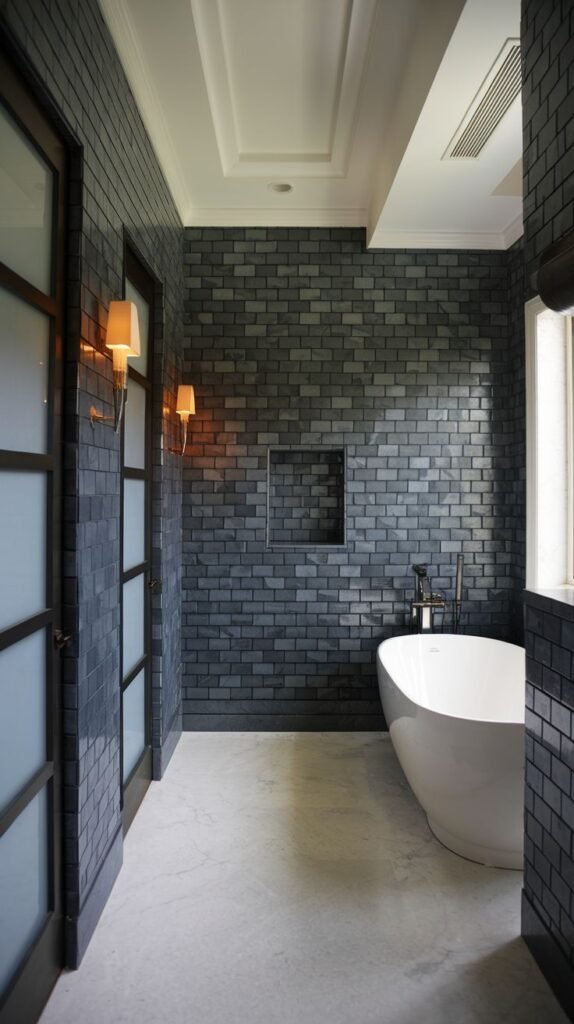 A modern bathroom with dark grey brick-patterned tiles on the walls, a white freestanding bathtub, and a light-colored floor, with frosted glass doors on the left.