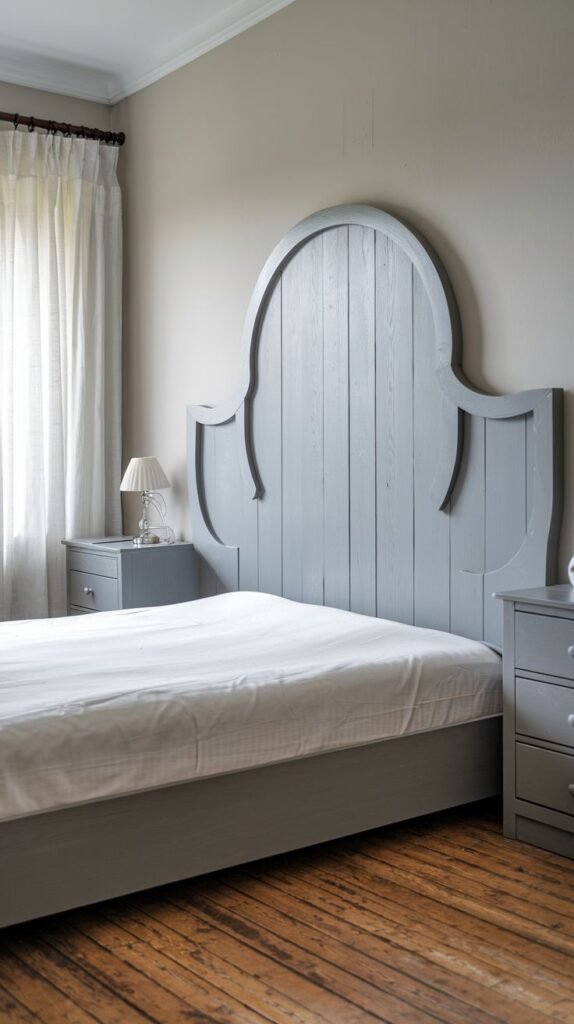 An elegant and rustic bedroom with an arched, wood-paneled Grey Headboard featuring carved details, and matching nightstands.