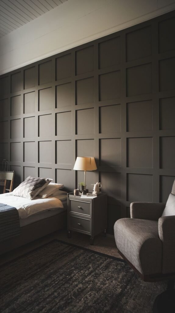 A cozy and sophisticated bedroom features dark charcoal grid wall paneling, providing a deep, grounding backdrop that can be achieved with PVC panels.