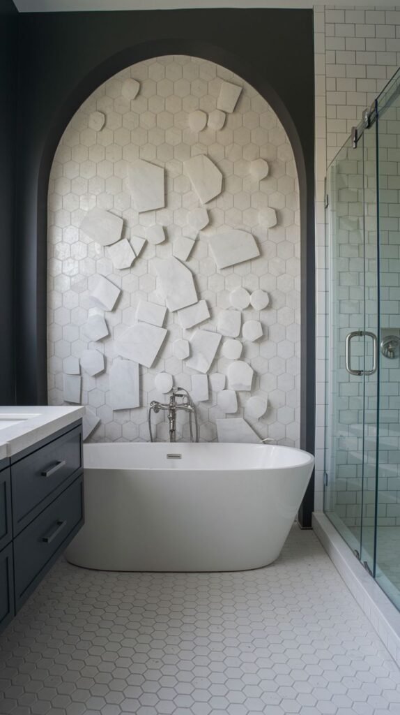 Contemporary luxury accent wall within a dark arched niche, featuring white hexagonal tile background overlaid with various floating, raised white 3D geometric shapes/slabs above a white tub.