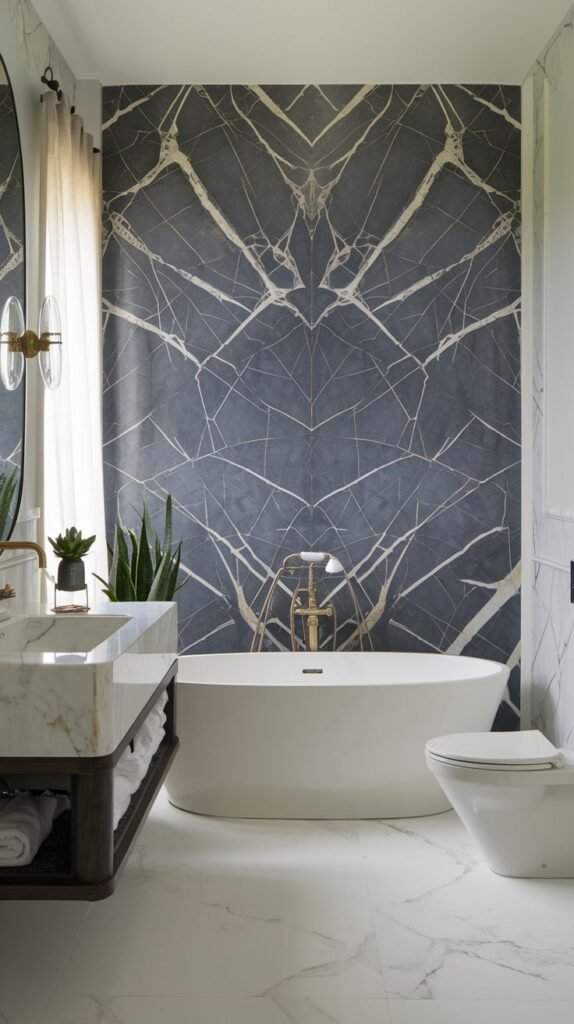 Striking modern luxury accent wall with a dark blue/charcoal background and symmetrical, radiating white and gold hairline veining, contrasting with a clean white tub.