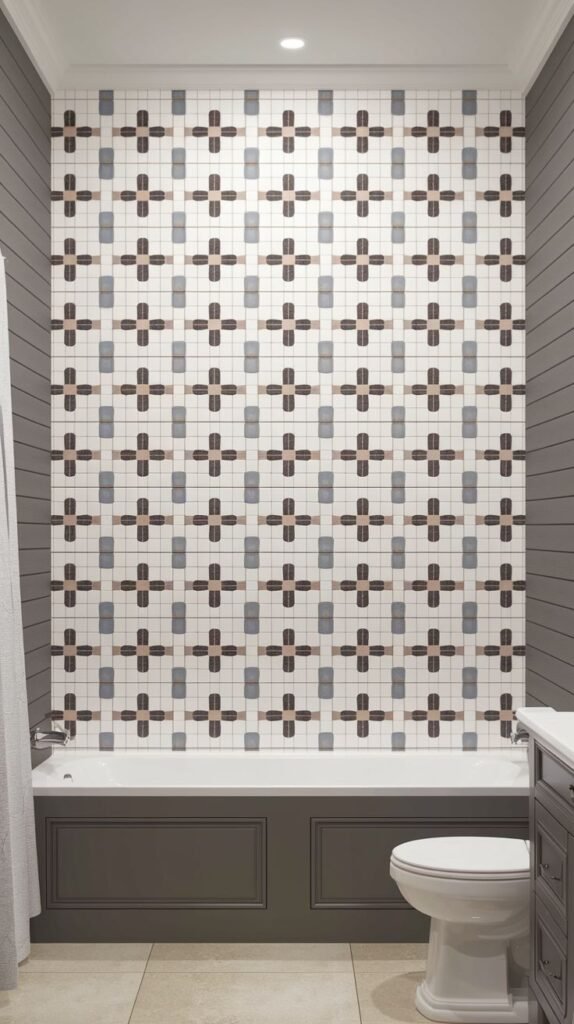 Graphic luxury shower accent wall covered in small mosaic tiles forming a continuous repeating pattern of crosses or plus symbols in earthy and cool neutral colors.