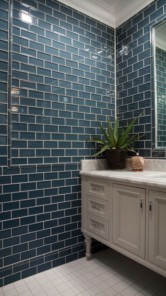 Deeply colored luxury shower accent wall clad entirely in glossy, deep teal/marine blue subway tiles set with light grout.