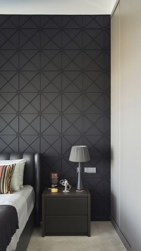 A narrow black accent wall covered entirely in a fine, repeating dimensional pattern resembling small squares or diamonds set within a grid.