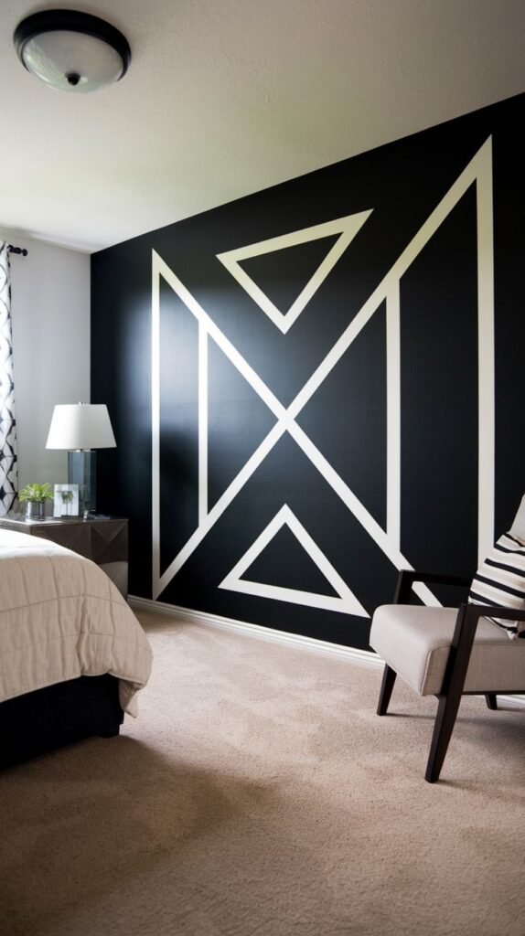 A black accent wall dominated by a large, central geometric motif created with thick white molding, outlining a central diamond and surrounding triangles.