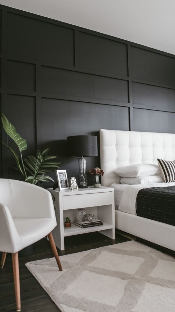 A classic black accent wall created using board and batten molding to form large, recessed rectangular panels, contrasting sharply with a white tufted headboard.