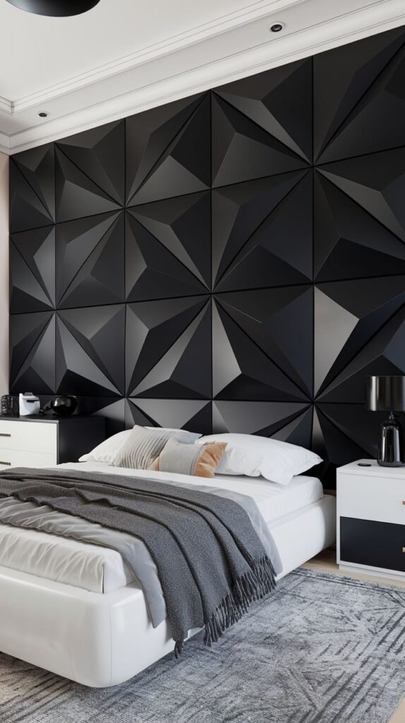 A dramatic black feature wall constructed from large, interlocking 3D geometric panels with faceted, pyramid-like surfaces that provide strong texture and shadow play.