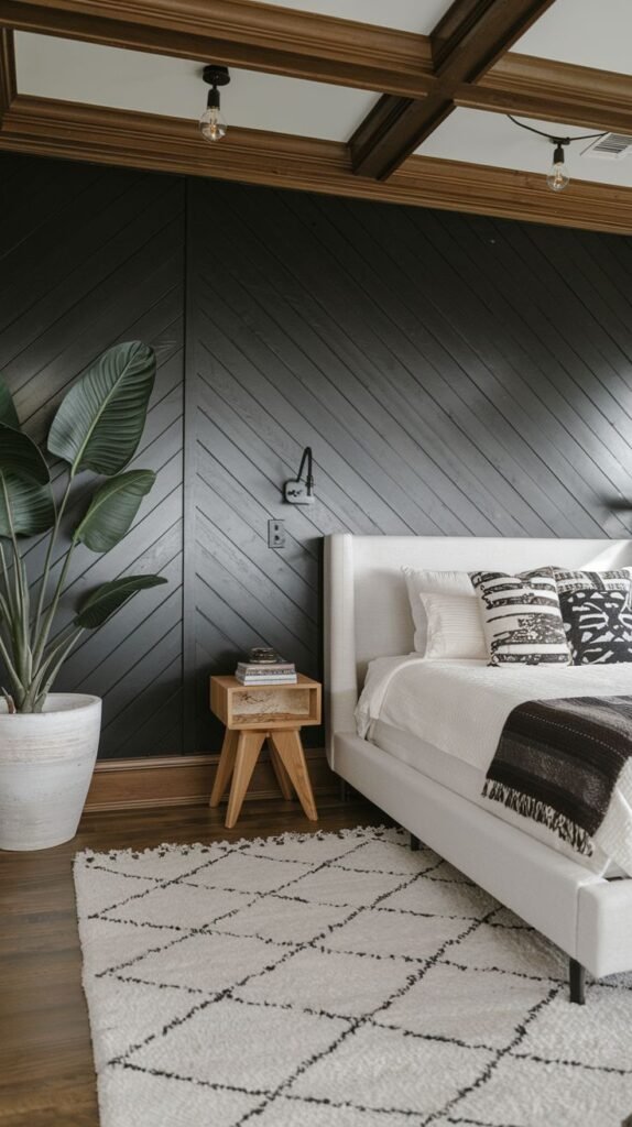 A modern bedroom featuring a black accent wall clad in dark wood planks laid diagonally, bordered by chunky natural wood trim that connects to the ceiling beams.