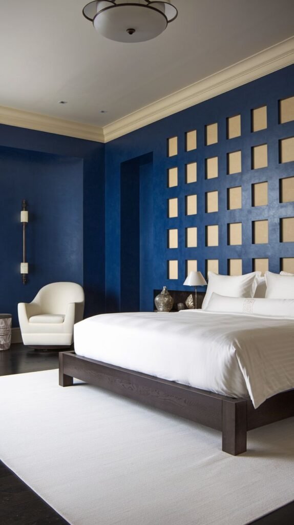 Deep Navy Wall with Square Recessed Grid Pattern Modern bedroom with dark navy blue walls, featuring a grid pattern of recessed square panels with a lighter background directly above the bed.