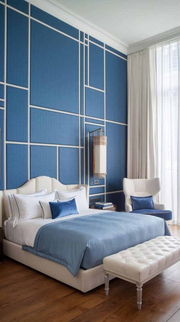 Bright Blue Textured Wall with Asymmetrical White Linear Trim Bright blue accent wall featuring a contemporary design created by asymmetrical white panel molding forming irregular geometric shapes, behind a light upholstered bed.
