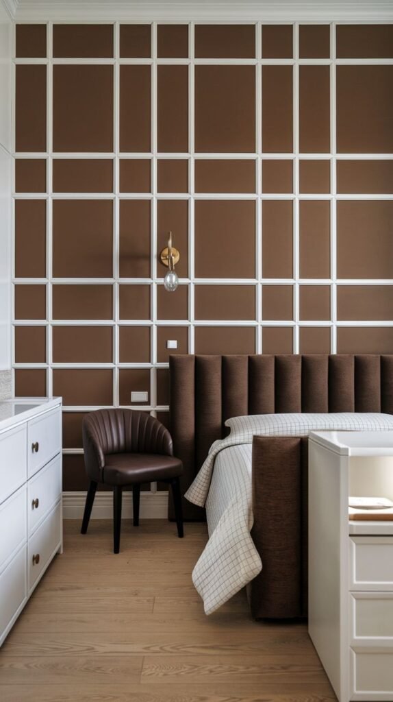 A medium brown accent wall decorated with a comprehensive grid pattern created by white wooden moulding that forms various sizes of rectangular panels.