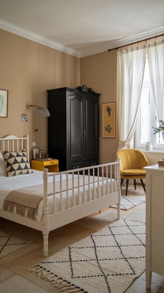 Bright bedroom combining a white spindle bed, a traditional black armoire, and a cheerful mustard yellow accent chair next to a large window.