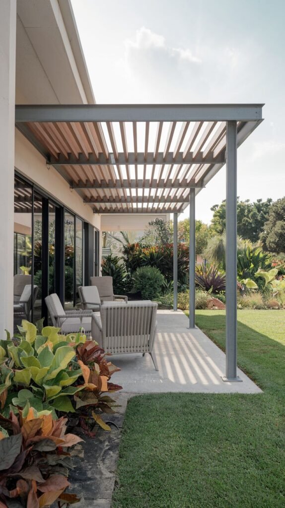 Contemporary patio structure with a metal frame and a roof composed of wooden slats alternated with translucent panels, providing partial shade and weather protection over a concrete patio.