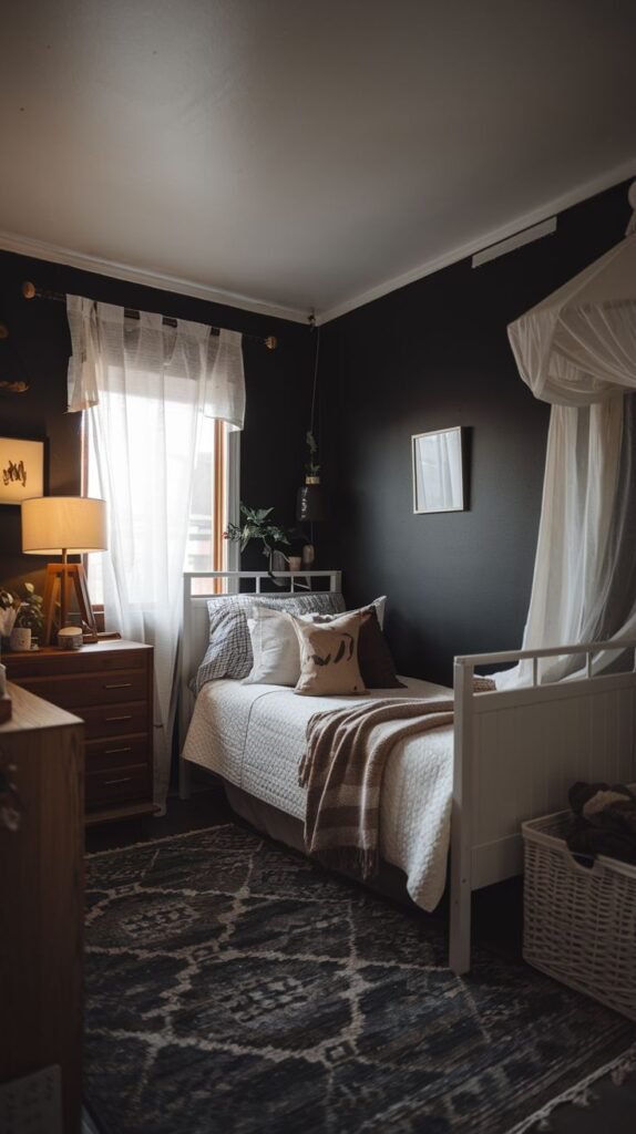 Dramatic Cozy Small Bedroom For Men with black walls, a white iron bed, a patterned rug, and sheer white curtains draped to resemble a partial canopy.