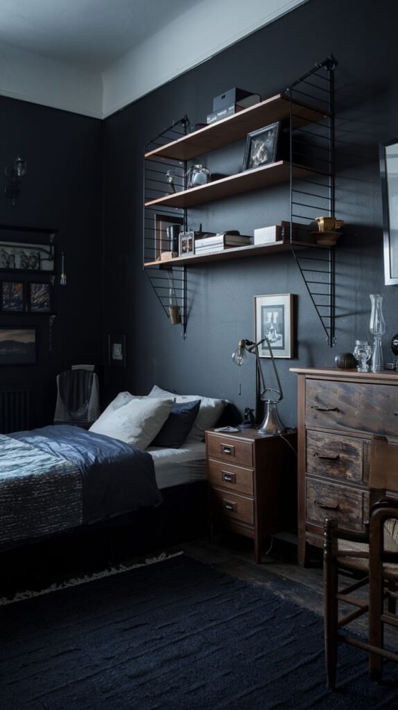 Rustic Industrial Cozy Small Bedroom For Men featuring dark walls, modern black string shelving, and a rustic distressed wooden chest of drawers.
