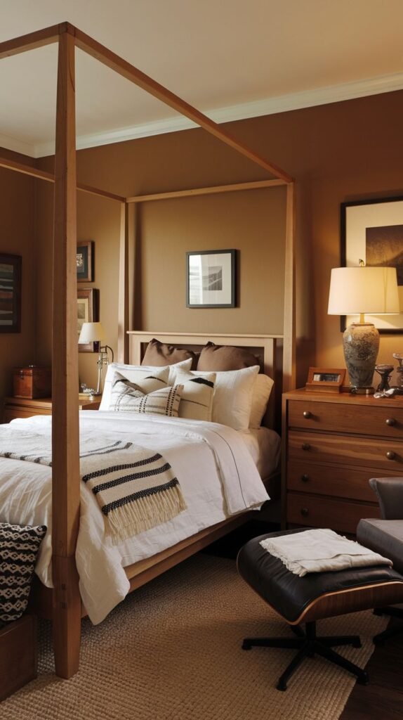 Rustic Elegant Cozy Small Bedroom For Men with warm brown walls, a substantial natural wood four-poster bed, and a dark leather armchair and ottoman.