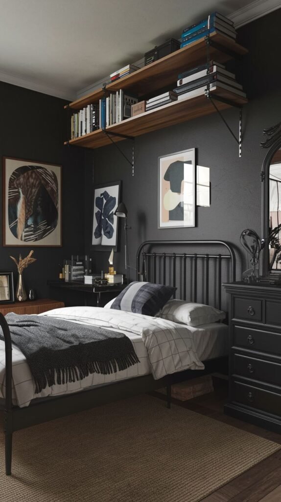 Dark and moody Cozy Small Bedroom For Men with black walls, a black metal bed, and high-mounted wooden floating shelves with industrial brackets.