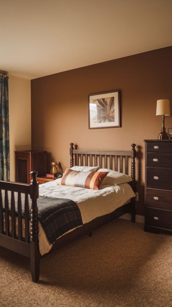 Classic Cozy Small Bedroom For Men utilizing a warm terracotta accent wall, dark traditional wood bed frame, and a tall matching chest of drawers.