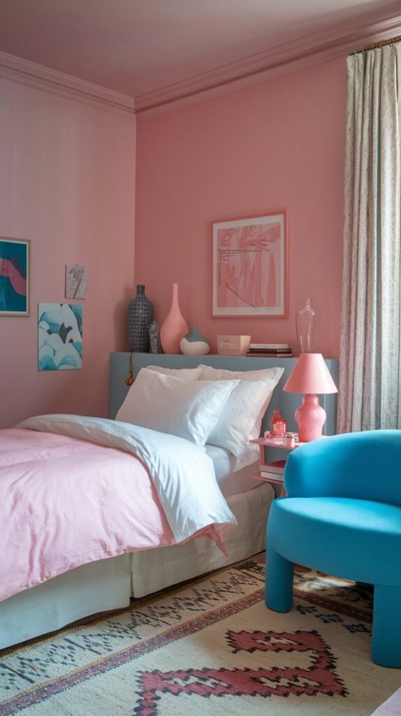 A bold, contemporary Cozy Small Bedroom for Women with walls painted fully in rosy pink, contrasted dramatically by a low blue headboard and a sculptural electric blue accent chair.