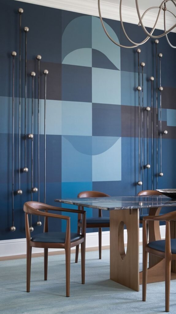 A deep blue accent wall featuring an abstract geometric mural in lighter shades of blue, decorated with applied sculptural elements consisting of long silver rods capped with spheres.