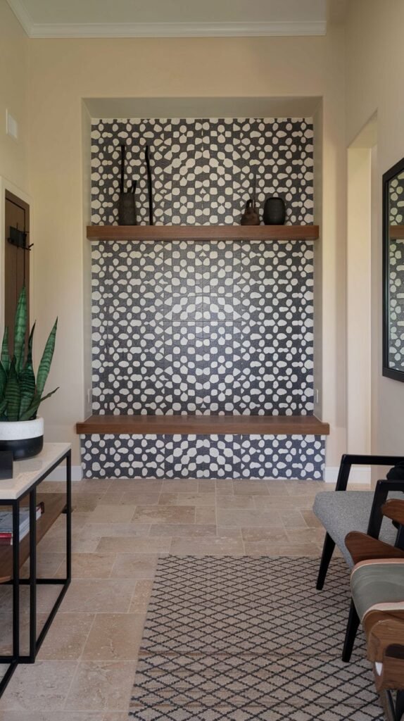 Recessed entryway niche wall covered in dark blue/black and white geometric tile pattern (repeating interlocking circles), featuring a wooden shelf and bench.