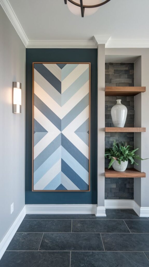 Vertical accent panel set against a navy wall featuring a geometric chevron pattern painted in varied shades of white and blue, framed by thin wooden trim.