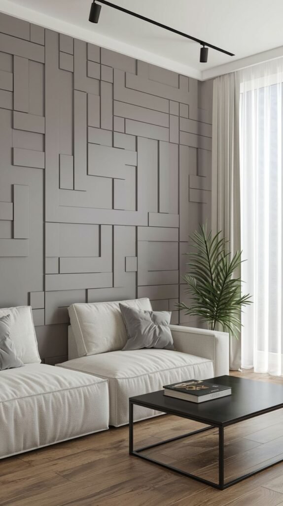 Contemporary accent wall covered in raised 3D panels forming a modular, abstract geometric pattern in a matte taupe or gray finish.