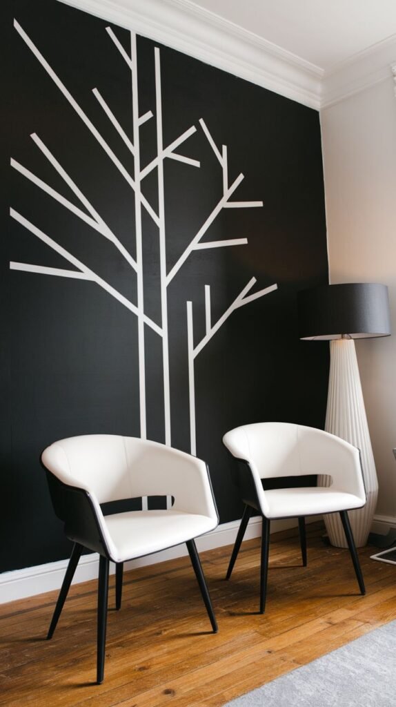 Black accent wall featuring a minimalist, abstract tree branch motif created using thin white linear strips, positioned behind two white and black armchairs.
