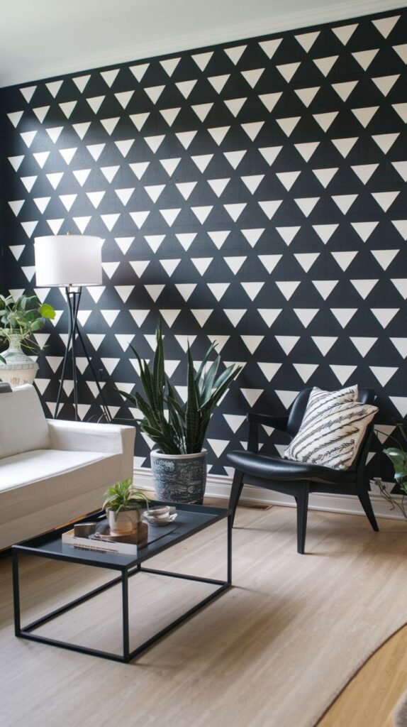 Black accent wall covered in high-contrast geometric wallpaper featuring a repeating pattern of white tessellating inverted and upright triangles.