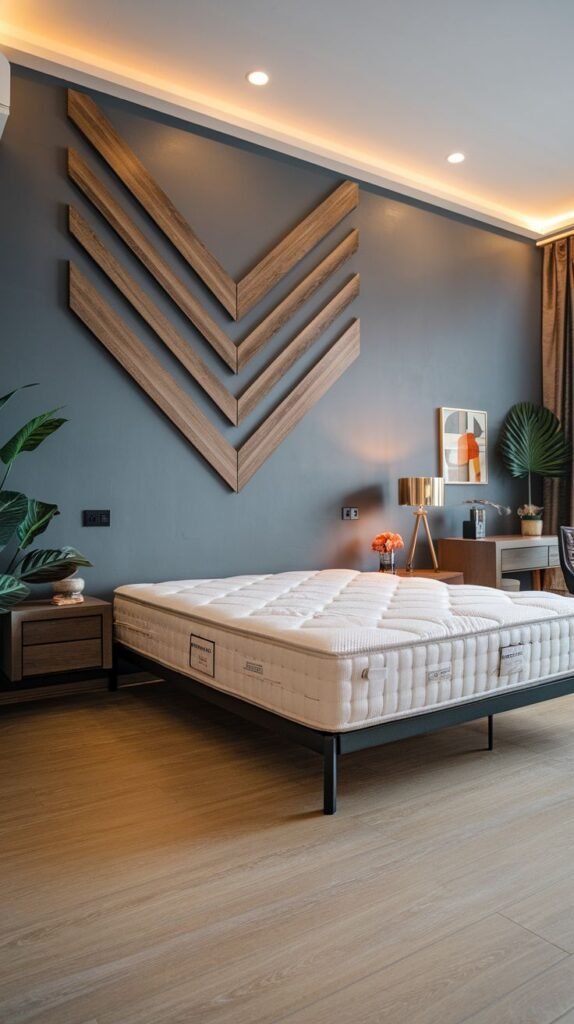 A bedroom with a dark teal painted wall adorned with three layered, angled wooden segments forming large, stylized V-shapes.