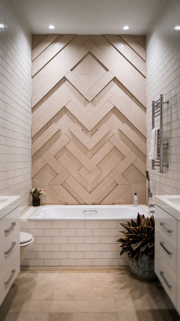 Narrow bathroom with a built-in tub flanked by white vanities, featuring a striking accent wall of neutral beige three-dimensional tiles arranged in an interlocking chevron pattern.