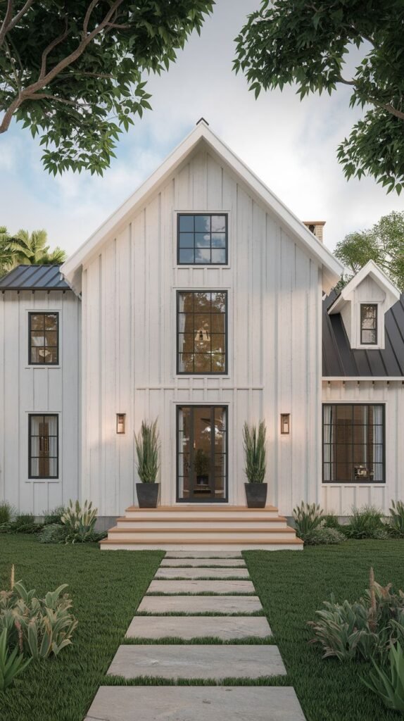 Front view of a white board-and-batten farmhouse with a black roof accent. The central entry is marked by vertically stacked black-framed windows, leading down via wide wood steps to a linear stone paver walkway set in the lawn.