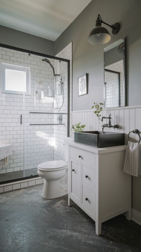 Modern Farmhouse Bathroom with a black vessel sink, industrial barn light, and distressed dark gray floor.