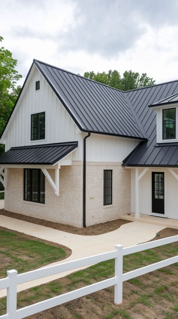 Modern farmhouse exterior blending materials: white board and batten siding on the upper level and light buff brick on the lower level, topped with a dark metal roof.