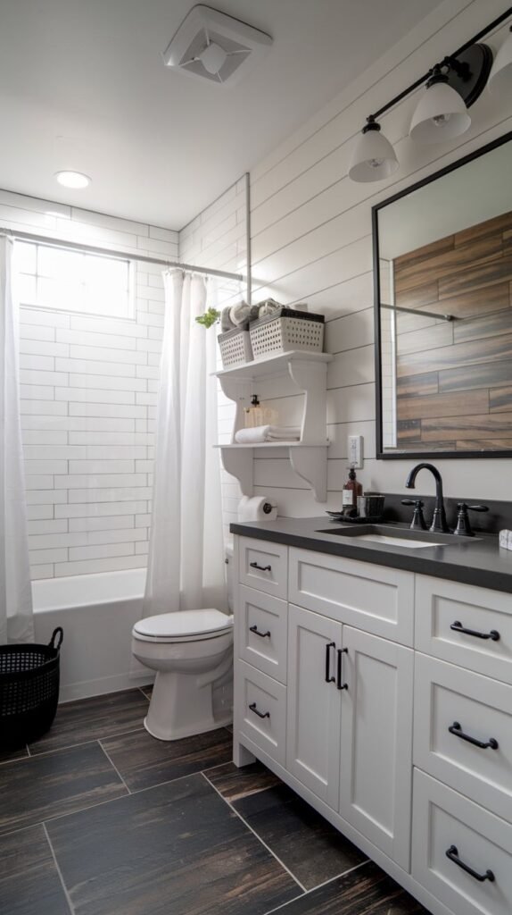 White vanity with black hardware, white horizontal shiplap walls, dark distressed wood-look plank floor tile, and a mirror featuring a horizontal wood grain accent in a compact Modern Farmhouse Master Bathroom.