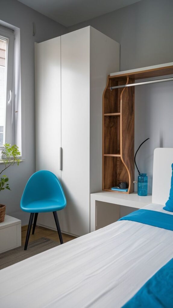 Modern Small Bedroom with a white wardrobe and an integrated wooden desk area with a hanging rod, highlighted by a bright, striking blue modern plastic chair.