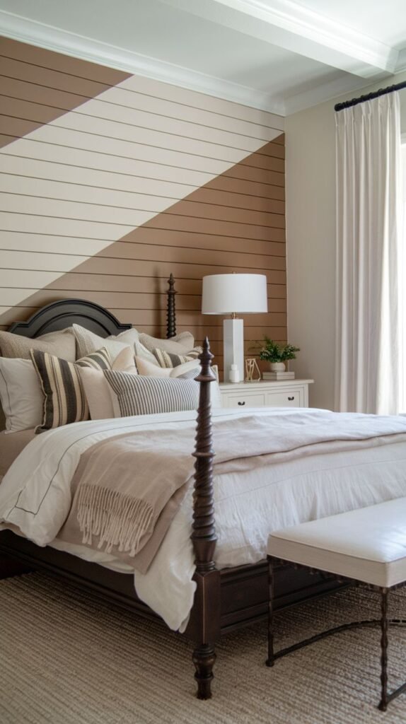 A bedroom featuring a dark spindle bed against a horizontal shiplap accent wall that is painted two-tone (tan and off-white) with a dramatic diagonal color division.